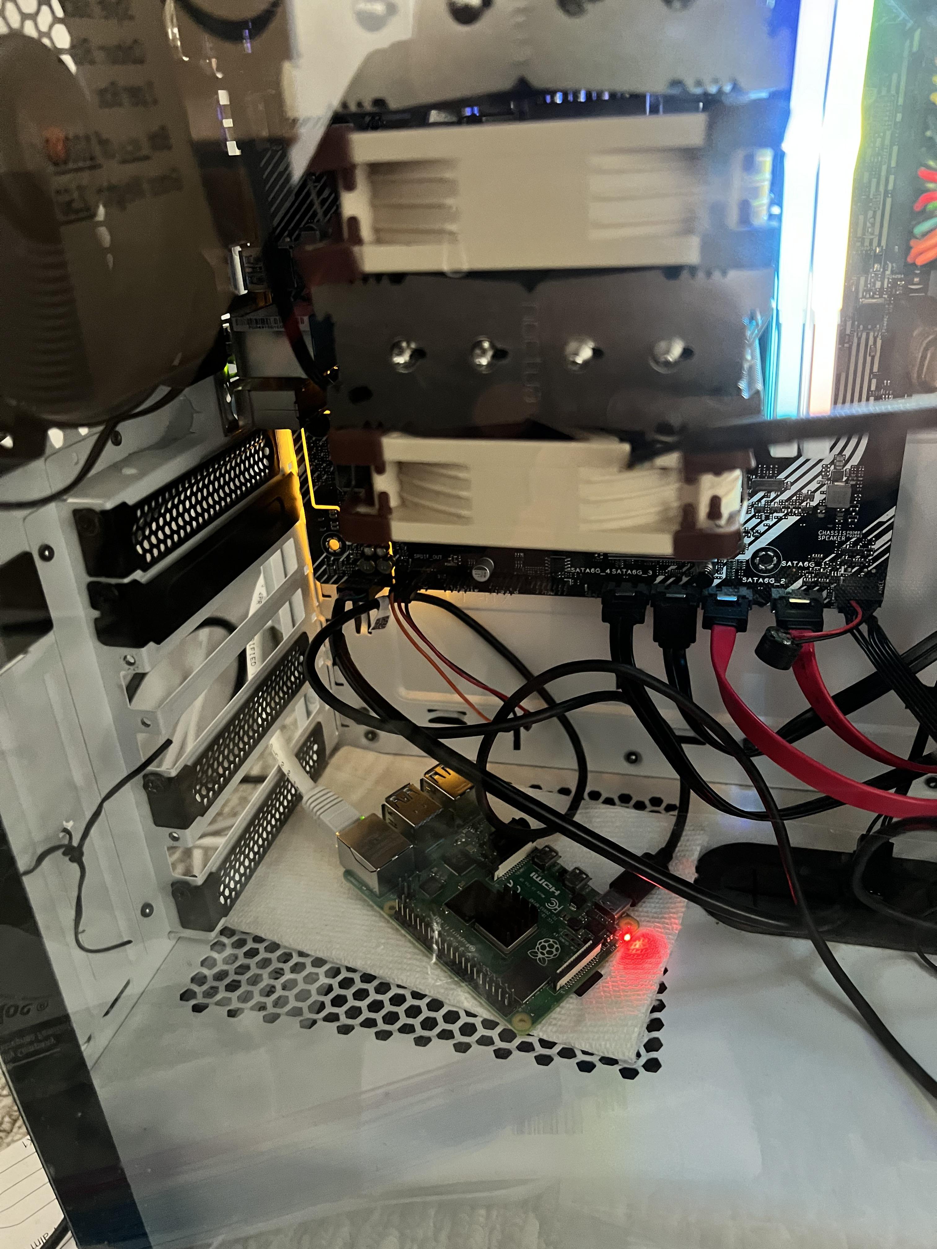 A picture of pneuma, my main shellbox node, with a Raspi 4B shown placed on top of a paper towel to shield from shorts against the aluminum frame of the case.
