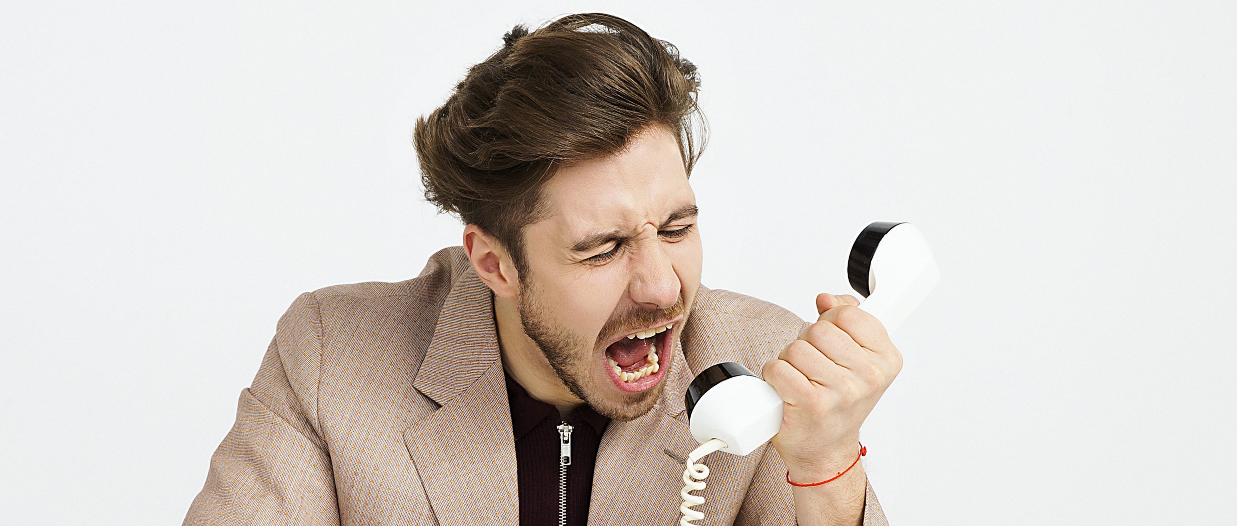 An image of A color-graded photo of a man screaming into a phone.
