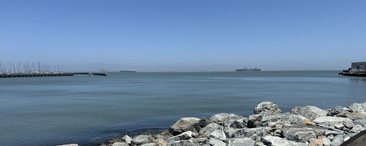 An image of A picture of the rocky shore of the San Francisco Bay on an idyllic sunny day.
