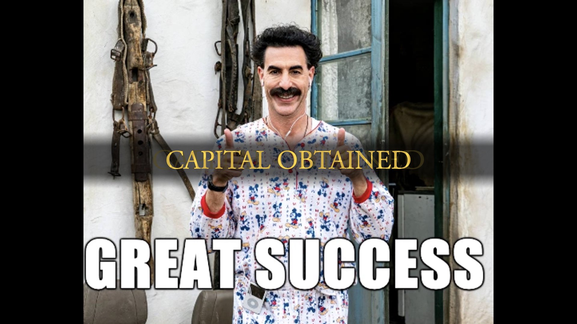 Borat holding two thumbs up with the caption 'Great success'. The words 'Capital obtained' are overlaid on top of the image like in Dark Souls when you kill a boss or something.